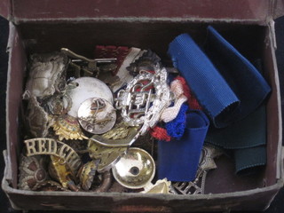 A box containing various military badges including Royal Fusiliers, RMP etc