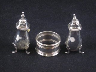 A pair of silver pepperettes and a silver napkin ring 3 ozs