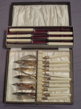 A set of 6 silver plated fish knives and forks together with a set  of 6 table knives, boxed