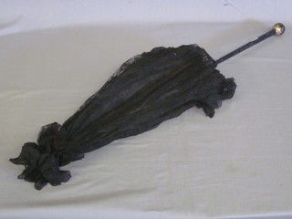 An Edwardian black lace parasol with turned ebony handle