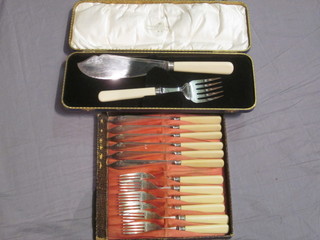 A pair of silver plated fish servers and a set of 6 silver plated fish knives and forks