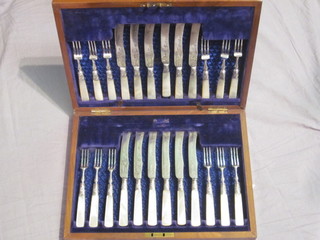 A set of 12 Victorian silver plated dessert knives and forks with ivory handles, contained in a walnut canteen box