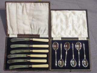 A set of 6 silver plated apostle teaspoons and a set of 6 tea  knives, cased