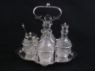 An oval pierced silver plated cruet frame with 4 cut glass bottles