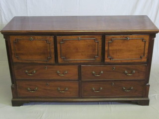 A Georgian mahogany dresser base fitted 3 cupboards above 4  long drawers, raised on a platform base with fluted columns to  the sides, 63"  ILLUSTRATED