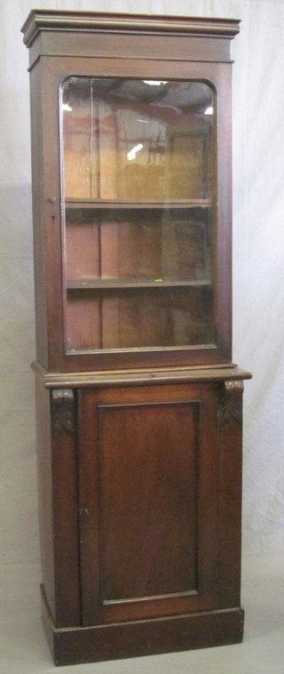 A Victorian mahogany bookcase on cabinet, the upper section  with moulded cornice, the shelved interior enclosed by a glazed  panelled door, the base fitted a cupboard enclosed by panelled  door 24"