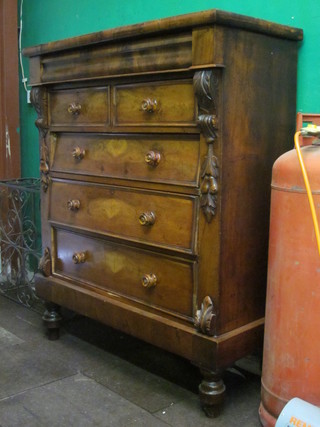 A Victorian Cumberland chest fitted a secret drawer above 2  short and 3 long drawers with scroll decoration to the side, raised  on turned supports 50"