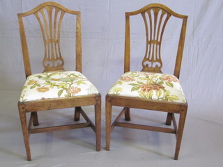 A pair of 19th Century Country elm Hepplewhite style dining  chairs with upholstered seats, raised on square tapering supports
