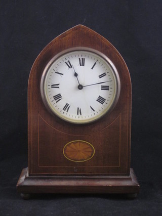 A bedroom timepiece with enamelled dial and Roman numerals  contained in an inlaid mahogany lancet shaped case