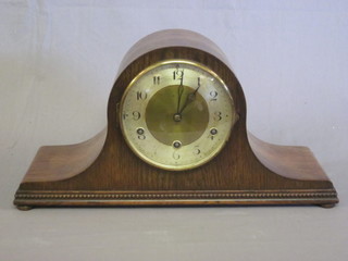 A 1930's chiming mantel clock with silvered dial and Arabic  numerals contained in an oak Admiral's hat shaped case