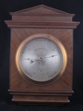 An aneroid barometer with silvered dial contained in a walnut case by Negretti and Zambra 9"