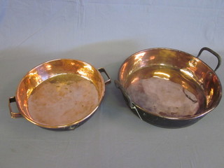 A circular copper twin handled dish 14" PLEASE NOTE LOT 203 IS ONLY THE DISH SHOWN ON THE LEFT HAND SIDE OF THE PHOTOGRAPH 