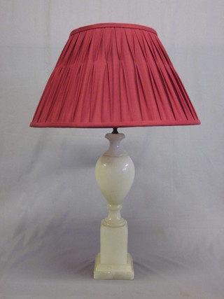 An alabaster bulbous shaped table lamp, raised on a square base 18"