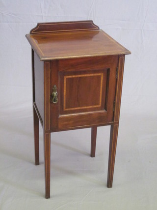 An Edwardian inlaid mahogany bedside cabinet with raised back enclosed by a panelled door, raised on square tapering supports  16"
