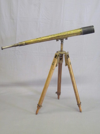 A polished brass and steel 2 draw telescope by W Ottway & Co  Ltd, marked 1940 no. 1465, reputedly removed from an  Australian tank, raised on a War Office issue brass and beech  tripod by the standard instrument no.13 Mk 3 New Zealand  1943,