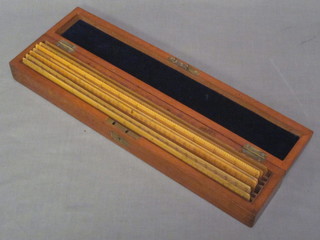 6 wooden rulers by J Halden & Co, London & Manchester  and 1 other by F.McC contained in a rectangular wooden box with hinged lid