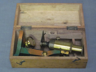 A 19/20th Century brass single pillar microscope contained in a  wooden box