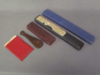 An Exactus calculator, a thermometer, a pair of pocket scales and  2 slide rules