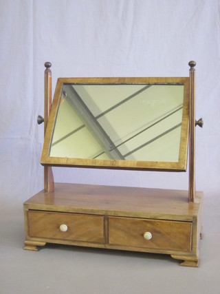 A 19th Century rectangular plate dressing table mirror contained  in a mahogany frame, the base fitted 2 drawers with turned ivory  handles, raised on ogee bracket feet 18"