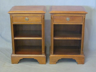 A pair of Georgian style mahogany bedside cabinets with canted corners, each fitted a drawer above a recess, raised on bracket  feet 17"