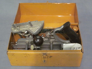 A Stanley 45 plane contained in a metal tin with instructions