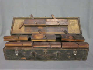 A carpenters tool box containing 10 various moulding planes