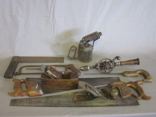 A steel smoothing plane, no handle, a wooden smoothing plane,  a blow lamp, 2 saws and other tools