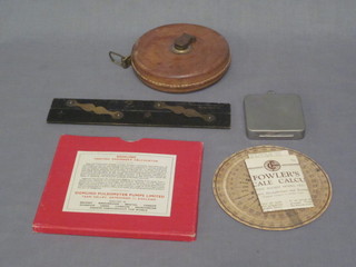 A Fowler's long-scale calculator together with a 66' tape  measure, a Simplex compass bearing converter, 1 other calculator  and a parallel ruler