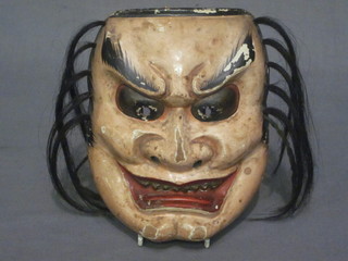 An Oriental carved and painted mask 6"