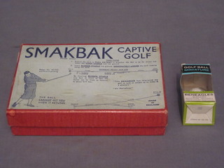 A Smakbak Captive golf together with a Gleneagles No.3 Scotch Whisky golf ball with contents