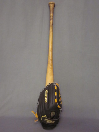 A signed baseball bat together with a ballpark baseball glove