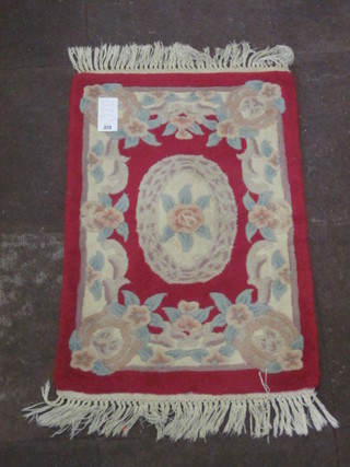 A red ground floral patterned Chinese rug 34" x 22"