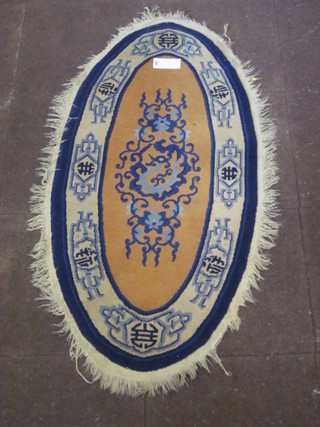 A 1930's Chinese oval blue ground rug 55" x 27"