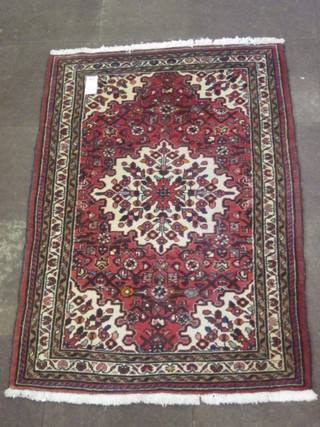 A contemporary red ground Persian carpet with central  medallion 67" x 41"