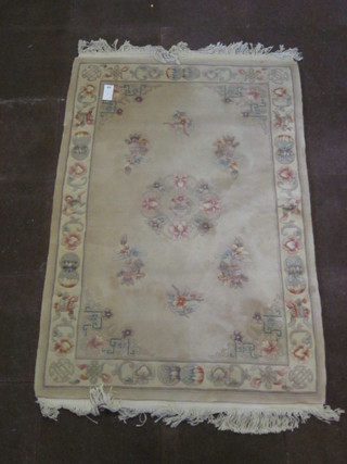 A Chinese peach ground and floral patterned rug 73" x 48"