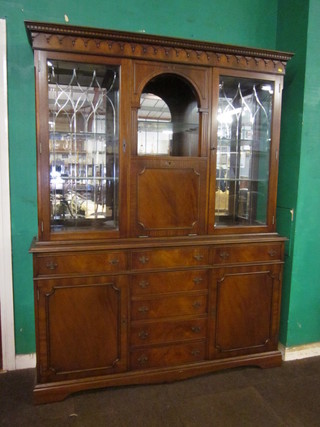 A Georgian style mahogany bookcase on cabinet, the upper section with moulded and dentil cornice with niche above a fall  front, flanked by a pair of cabinets fitted adjustable shelves  enclosed by glazed panelled doors, the base fitted 7 drawers  flanked by a pair of cupboards raised on bracket feet 59"