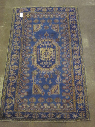 An "Afghan" blue ground rug, the central medallion within multi borders, 87" x 49"