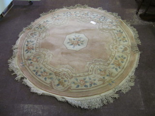 A circular peach and floral patterned Chinese rug 76"