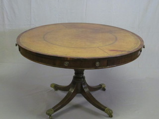 A Victorian circular rosewood drum table with tooled brown  leather writing surface, fitted 4 drawers, raised on bulbous turned  and tripod supports ending in paw feet and castors 48"   ILLUSTRATED