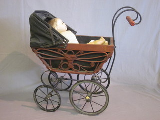 A reproduction Victorian perambulator together with a doll