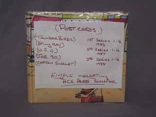 An album containing Thunderbird coloured postcards