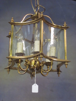 An octagonal gilt metal and glass 6 light hall lantern
