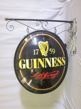 A plastic and iron oval Guinness advertising sign 27"
