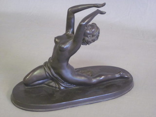 A bronzed figure of a kneeling semi-naked lady, raised on an  oval base 12"