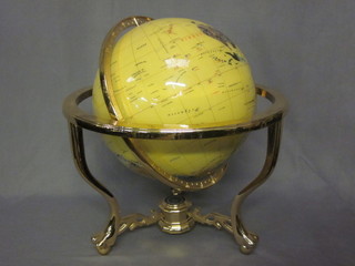 A terrestrial globe set semi-precious stones, set on a polished gilt metal stand 18"