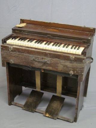 A Missionary harmonium by R F Stevens, contained in an oak case