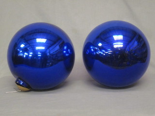 2 circular blue glass Witches balls