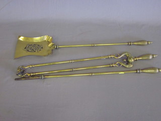 A good quality brass 3 piece fireside companion set comprising  shovel, poker and tongs, with reeded handles