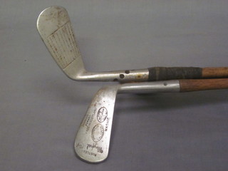 A Manton & Co Mashie hickory shafted golf club, a Caddi'e  Maxwell mid iron and an A J Marriott Special