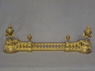 A French pierced gilt metal fire curb supported by urns 39"